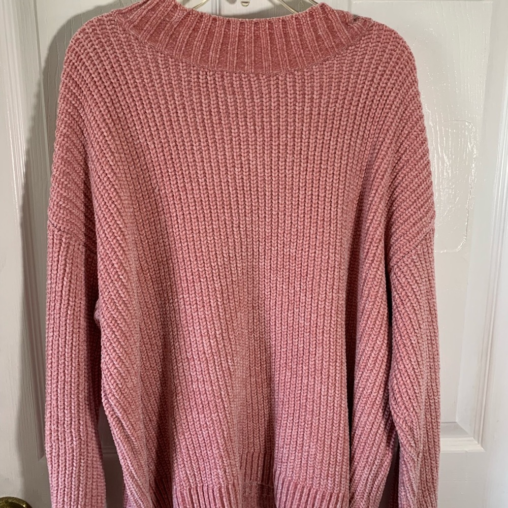 a pink sweater